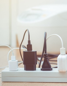 Several electronic items plugged into a surge protector.